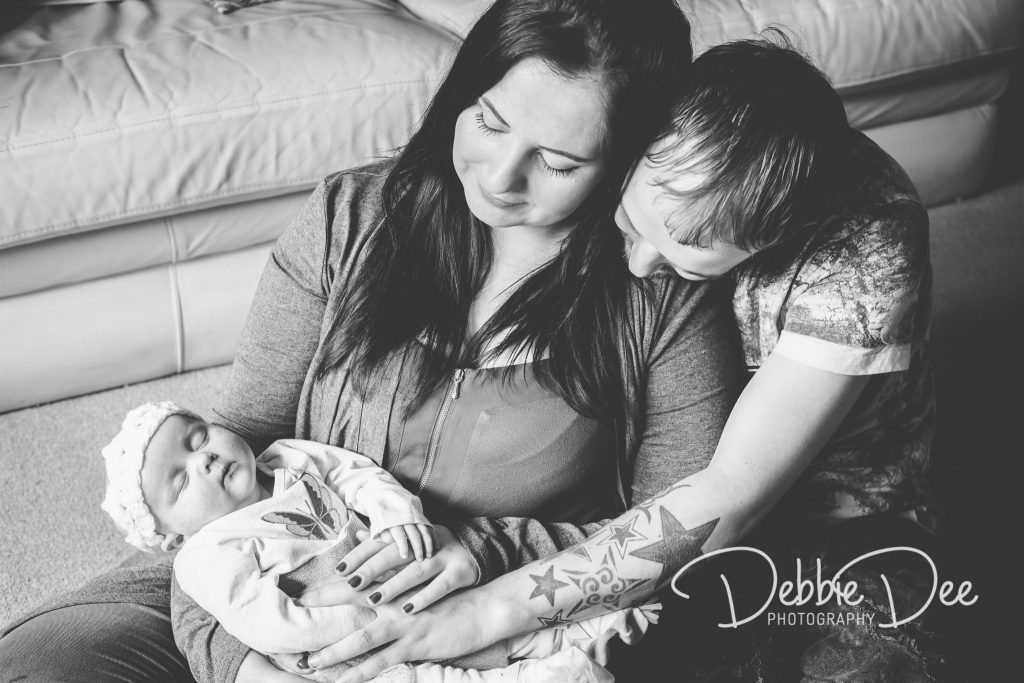 Family photography in-home lifestyle session aberdeenshire Debbie Dee Photography Mum and Dad looking down at baby