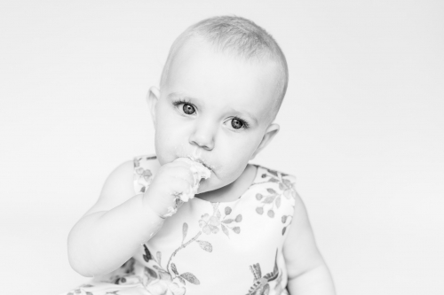 Black and white child&#039;s face eating cake at smash and splash session - aberdeenshire photographer Debbie Dee Photography