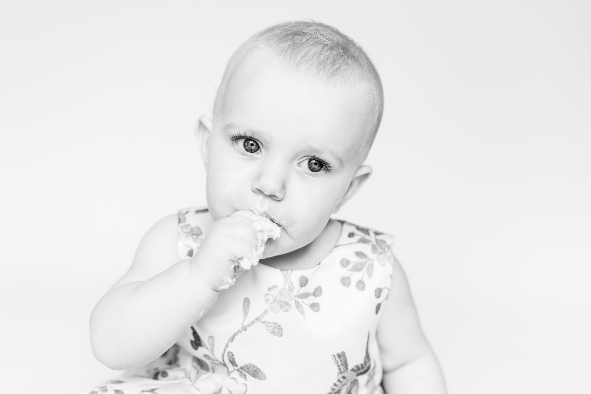 Black and white child's face eating cake at smash and splash session - aberdeenshire photographer Debbie Dee Photography