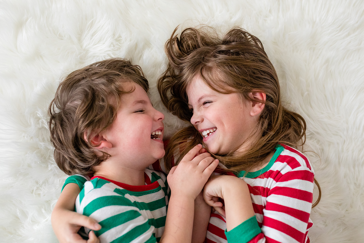 Siblings laughing and smiling at each other - Debbie Dee Photography - Aberdeen Photographer