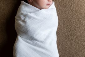 Newborn baby in white swaddle on brown blanket - baby photographer aberdeen - Debbie Dee Photography