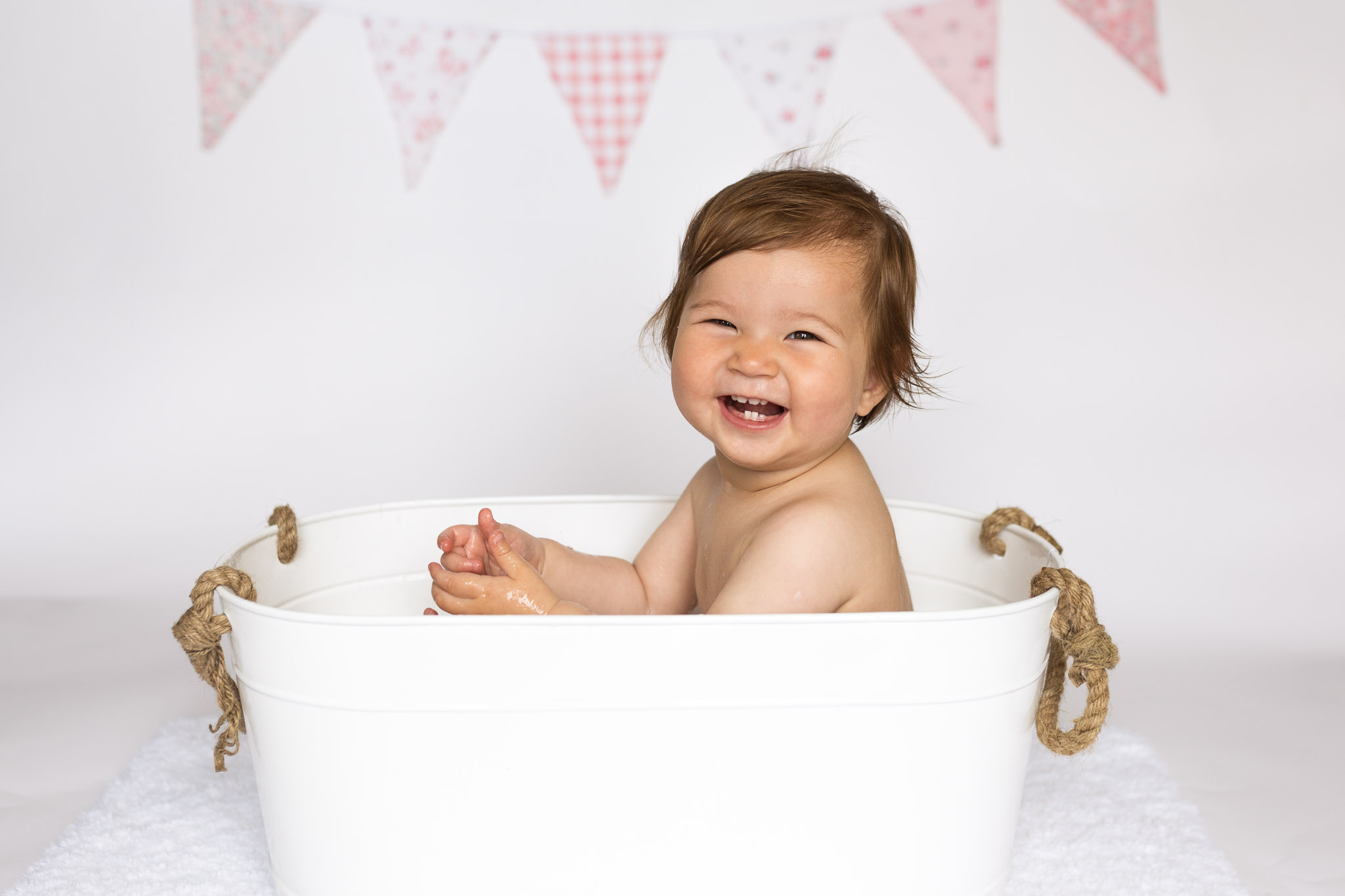 smiling in splash bath - cake smash aberdeen - Debbie Dee Photography